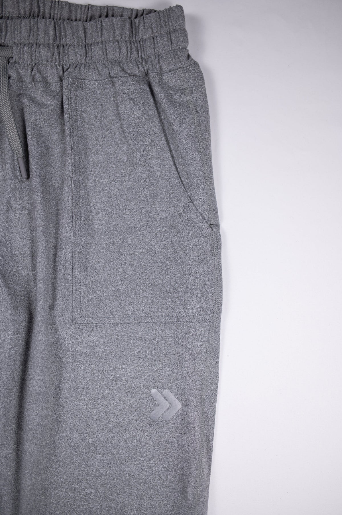Grey MOVE Sport Apparel Women’s Essential Joggers pocket and silver 3M reflective double-chevron thigh embellishment.