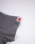 MOVE Sport Apparel women’s Merino Short Sleeve T-Shirt: Close view of the original red-and-white sleeve tab on the Granite Gray Merino shirt.