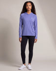 Woman modeling the MOVE Sport Apparel Women’s Lightweight Performance Hoodie in Deep Periwinkle in a neutral studio, showing the original small chest embellishment and sleeve lettering.