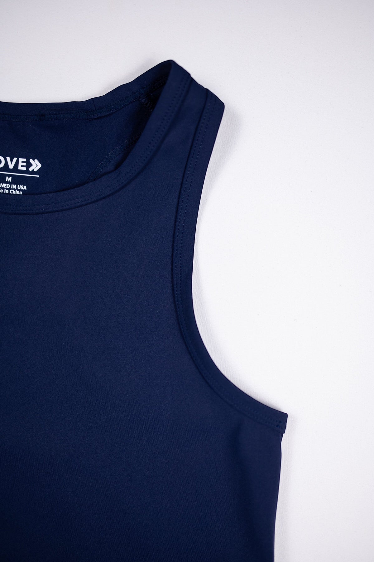 Close view of the neckline, shoulder seams and inner label on the Maritime Blue MOVE Sport Apparel Pure Stretch Full Length Tank Top.