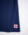 Close view of the original red-and-white hem tab on the Maritime Blue MOVE Sport Apparel Pure Stretch Full Length Tank Top.