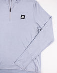 Close view of the chest patch and sleeve on the MOVE Sport Apparel Women’s Essential Quarter Zip in Silver Cloud.