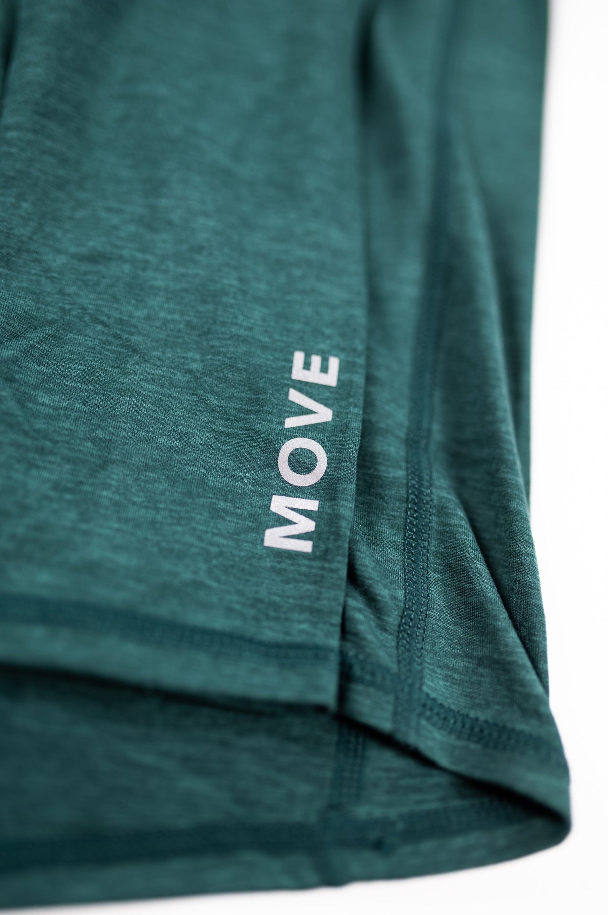 Close view of the Pine Grove fabric texture and sleeve lettering on the MOVE Sport Apparel Women’s Essential Quarter Zip.