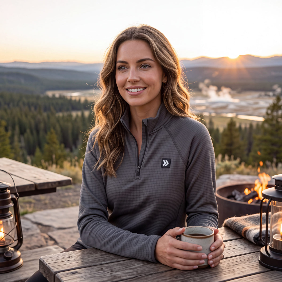 Woman wearing a charcoal grey MOVE sport apparel waffle-knit quarter zip pullover outdoors at sunset.