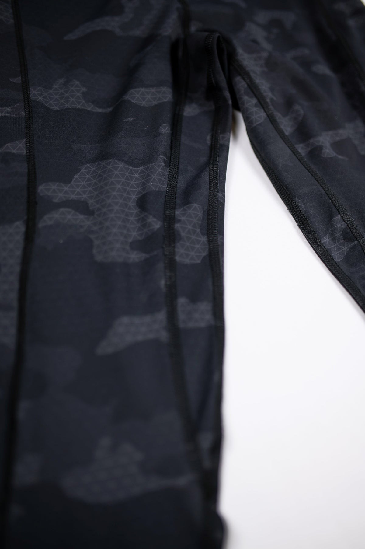 Close-up of Black Camouflage fabric and leg seams on MOVE Sport Apparel women’s 25-Inch Running Tights.