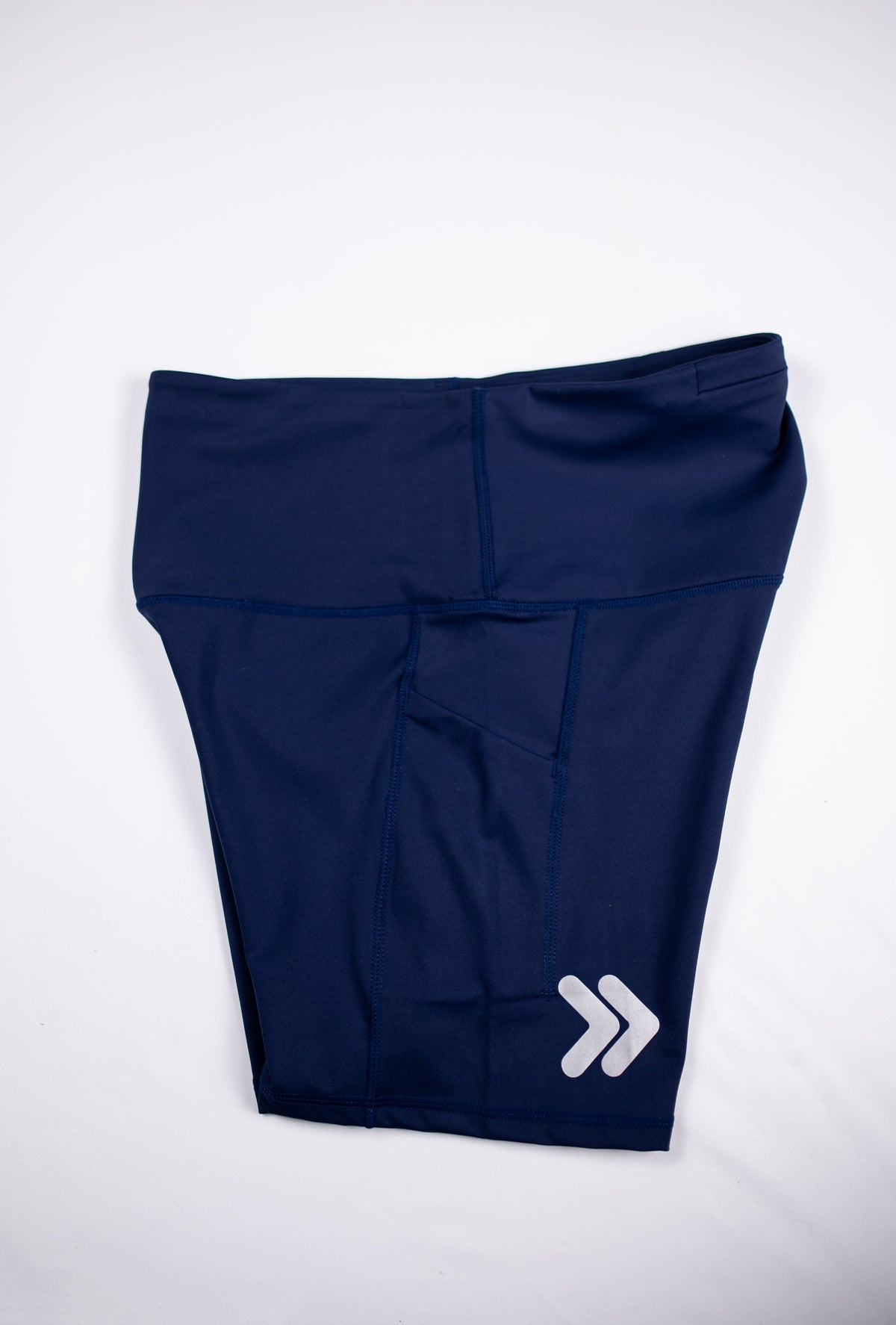 Maritime Blue MOVE Sport Apparel Women’s Biker Shorts folded to show the original silver embellishment near the hem.