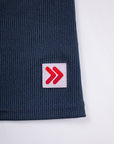 Close view of ribbing and the original red-and-white hem tab on the India Ink MOVE Sport Apparel Women’s FlexRib Full Length Tank.