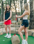 Two women wearing India Ink and Crystal Gray MOVE Sport Apparel Women’s FlexRib Full Length Tanks at a mini-golf course.