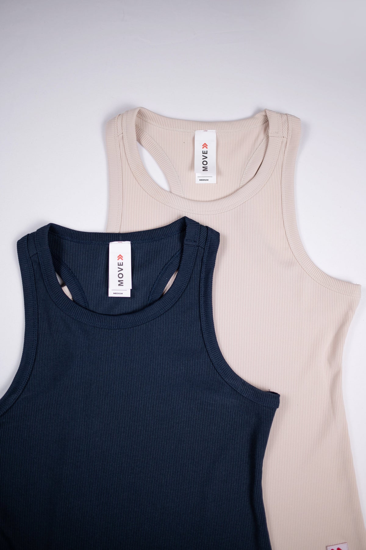 Necklines and inner labels on India Ink and Crystal Gray MOVE Sport Apparel Women’s FlexRib Full Length Tanks.