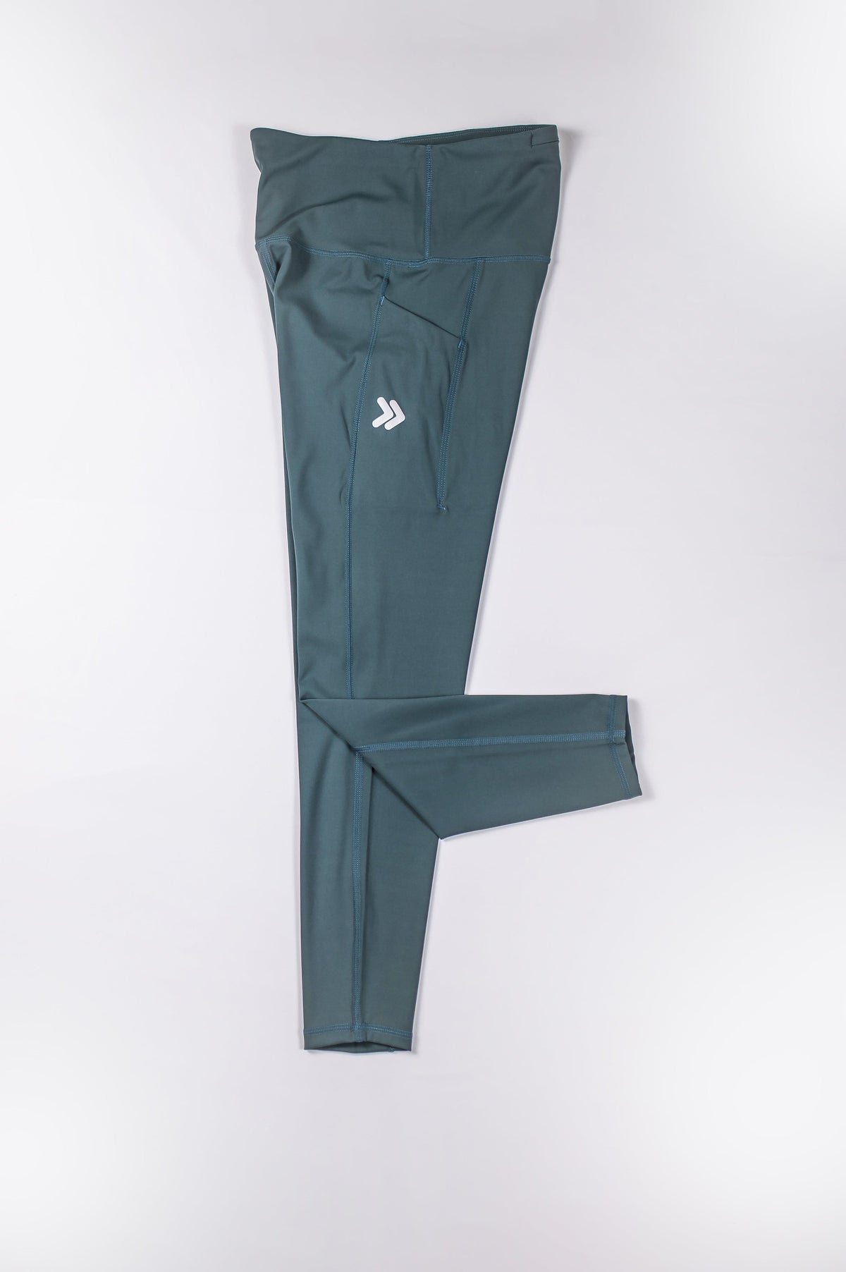 MOVE Sport Apparel women’s 25-Inch Running Tights: Balsam Green tights arranged with one leg folded.