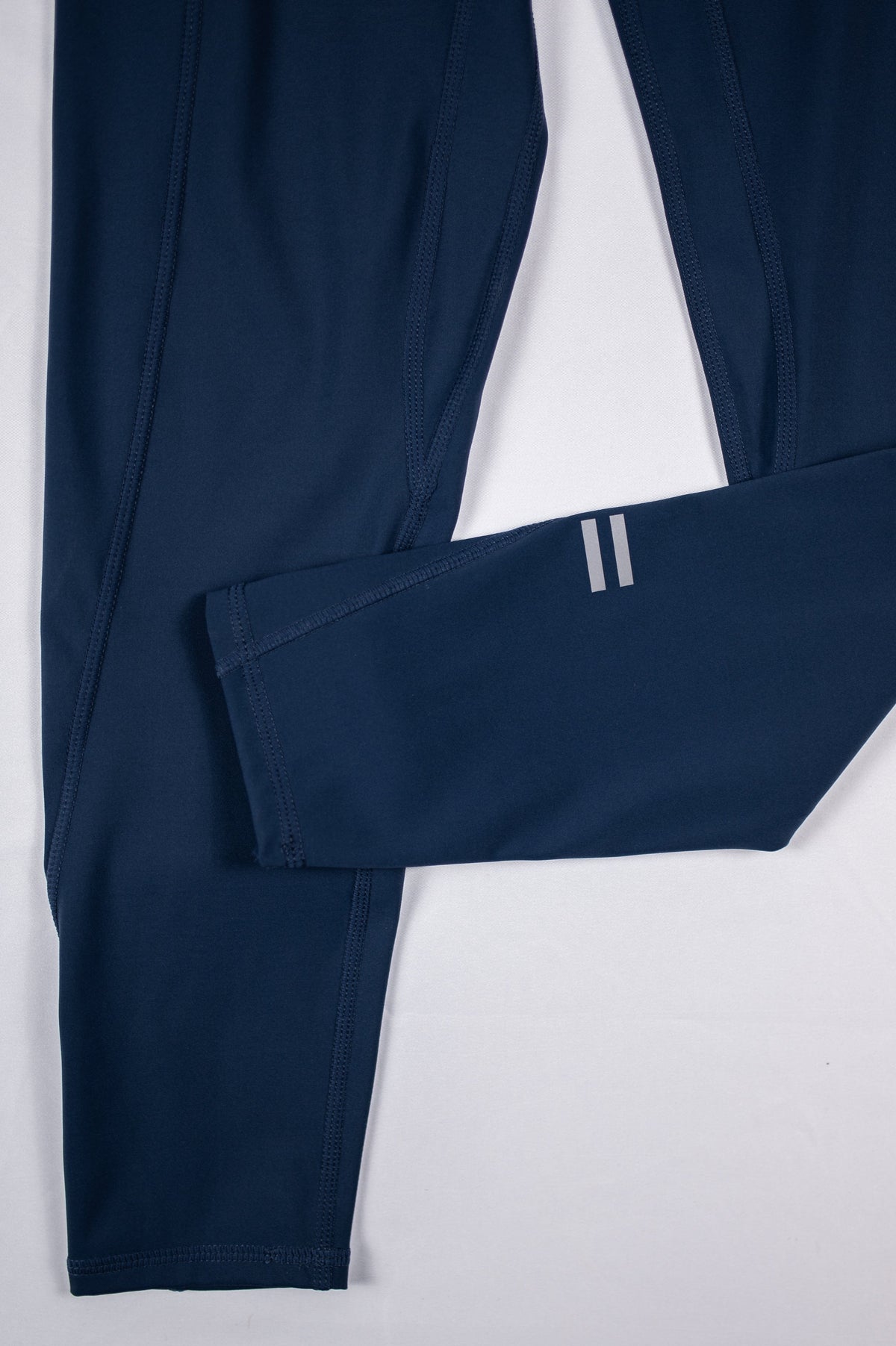 MOVE Sport Apparel women’s 25-Inch Running Tights: Close view of the original paired ankle bars on Pageant blue tights.