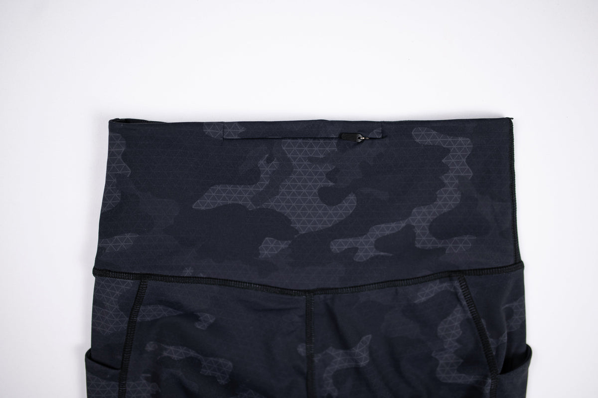 High waistband detail on MOVE Sport Apparel women’s 25-Inch Running Tights in Black Camouflage.