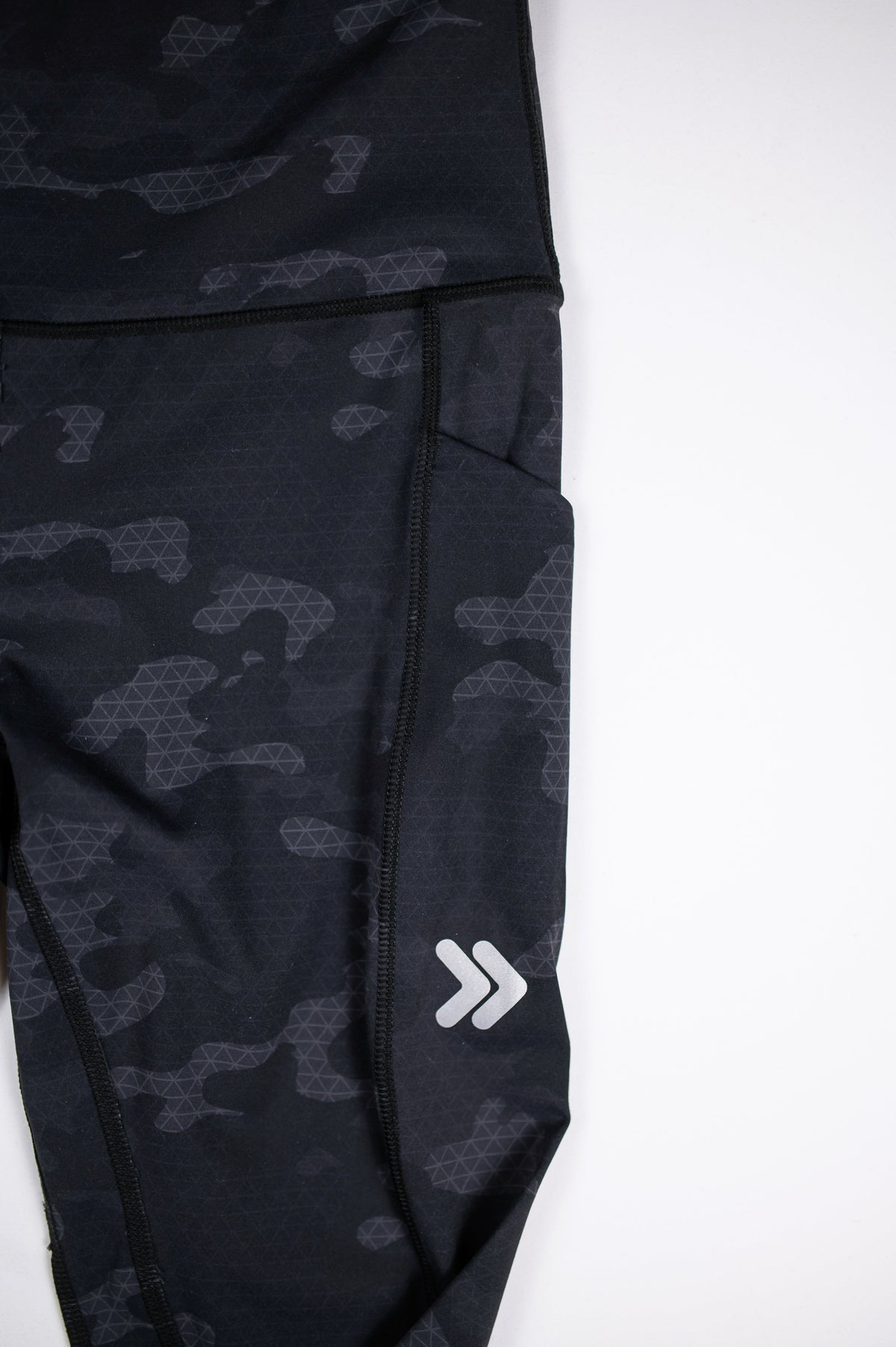 Original white thigh chevrons and side pocket on Black Camouflage MOVE Sport Apparel women’s 25-Inch Running Tights.