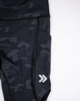 Original white thigh chevrons and side pocket on Black Camouflage MOVE Sport Apparel women’s 25-Inch Running Tights.