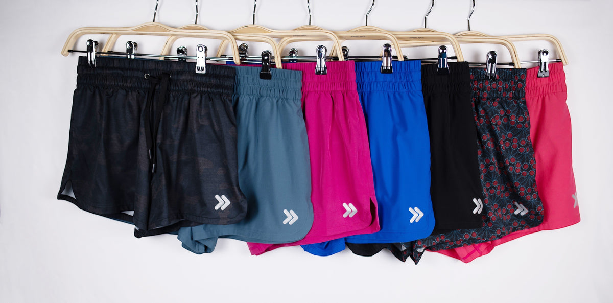 MOVE Sport Apparel women’s running shorts hanging together in several solid colors and prints.
