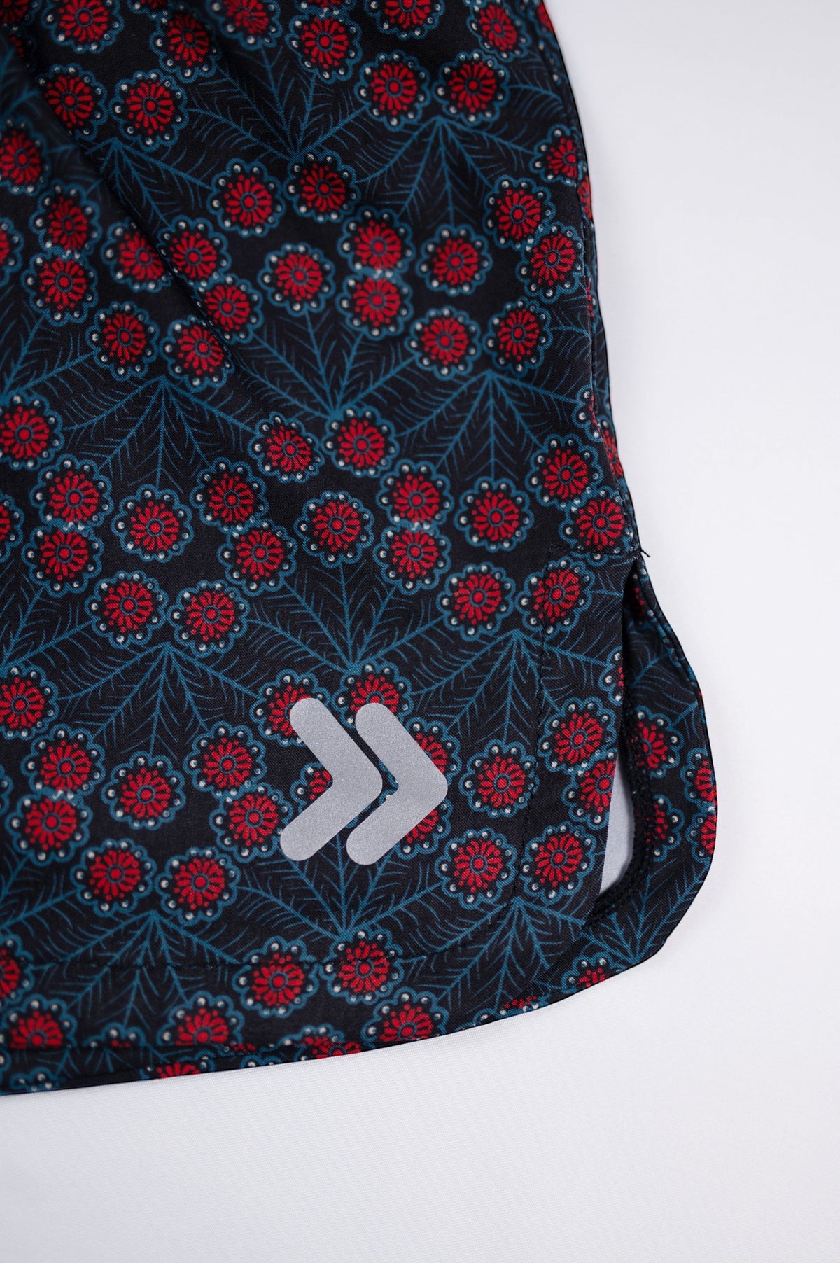 Flower Power printed running shorts showing the original white double-chevron embellishment.