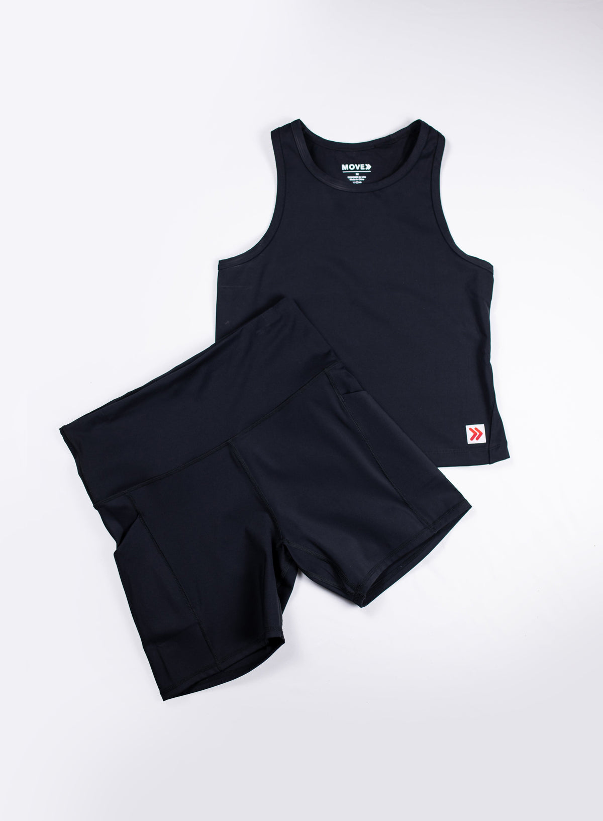 MOVE Sport Apparel women’s Biker Shorts: Black biker shorts arranged with a matching black cropped tank in a flat lay.