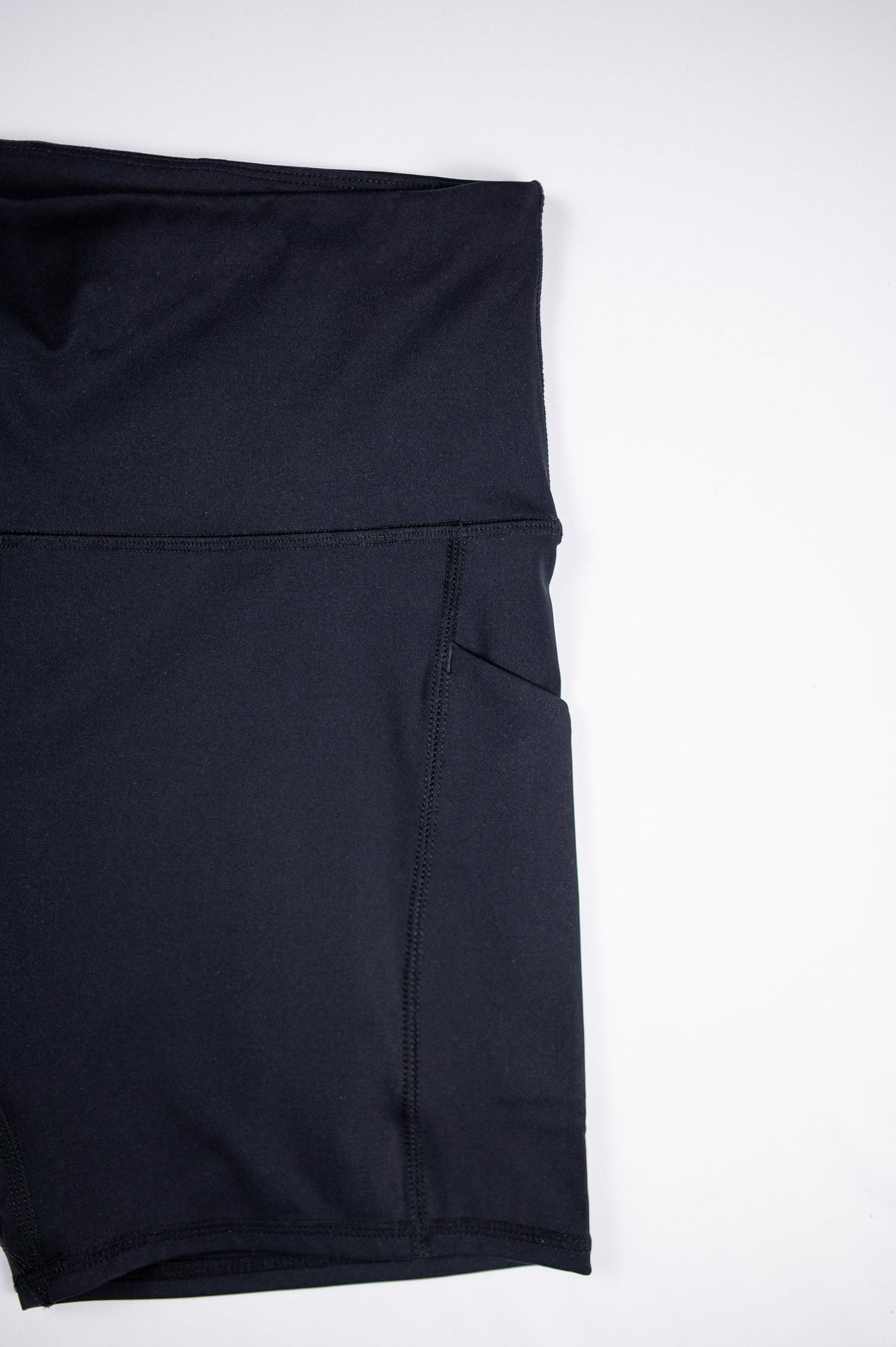 MOVE Sport Apparel women’s Biker Shorts: Close view of the side pocket and seams on Black biker shorts.