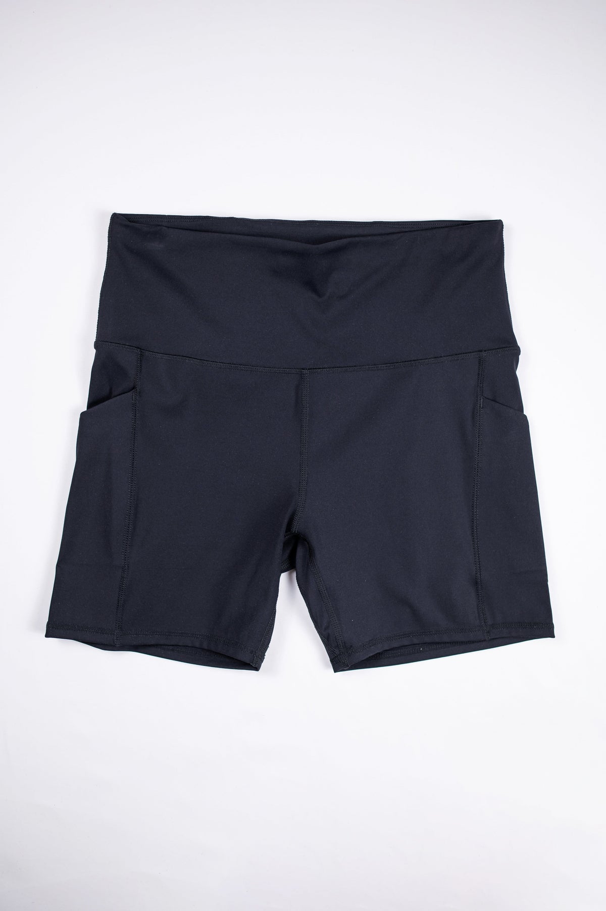 Front flat-lay view of black MOVE Sport Apparel Women’s Biker Shorts with a broad waistband and side pockets.