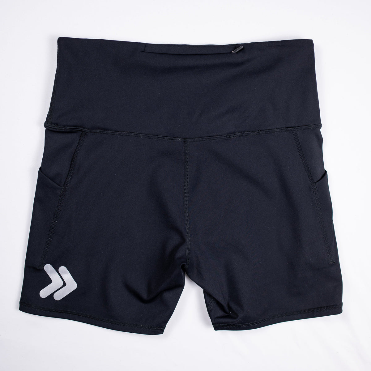 Rear flat-lay view of black MOVE Sport Apparel Women’s Biker Shorts with the waistband zipper and silver chevrons near the back hem.