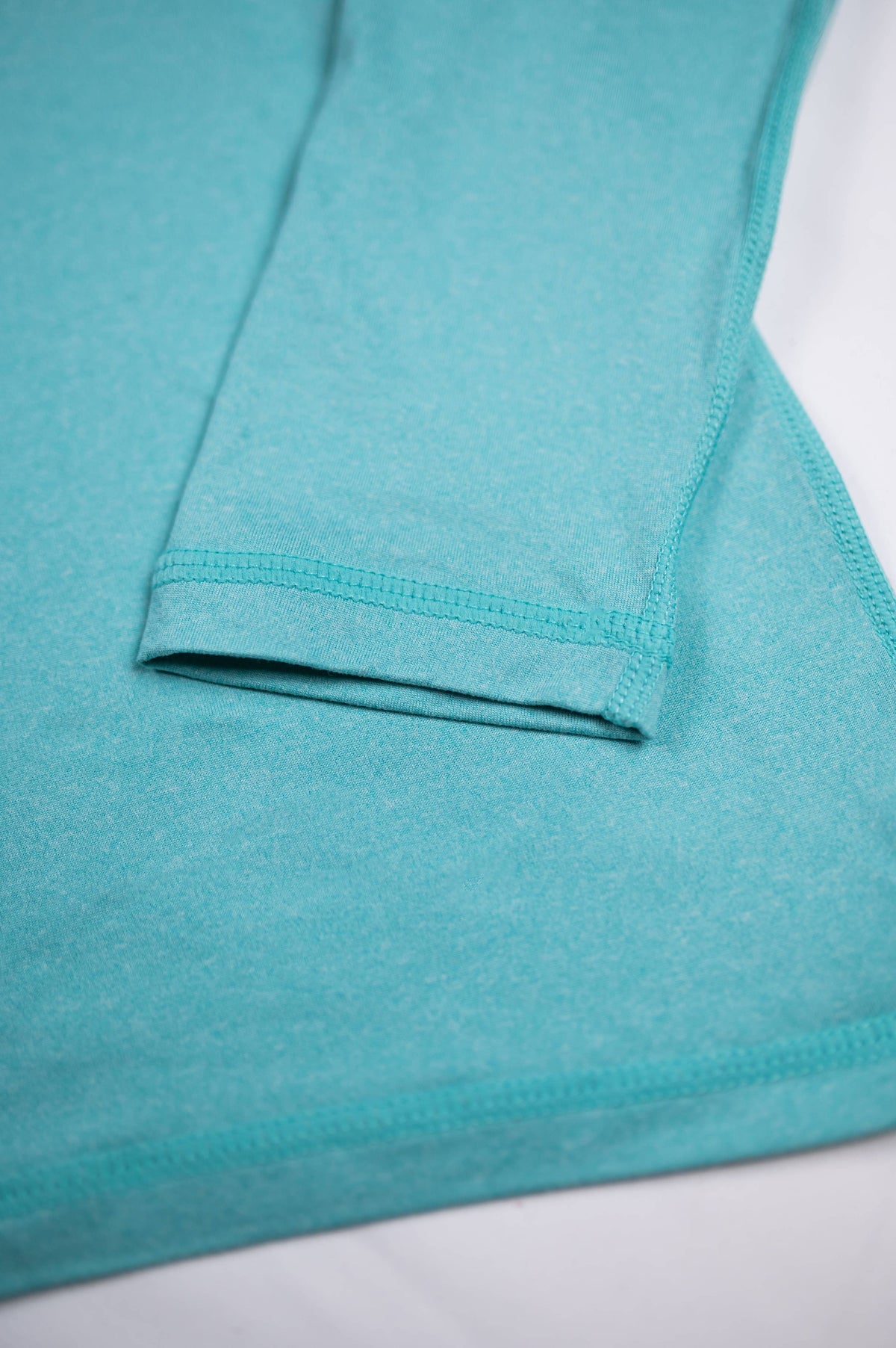 MOVE Sport Apparel women’s Black Label Lightweight Sun Hoodie: Close view of the Aqua Splash cuff and hem seams.