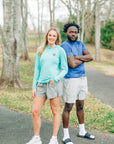 MOVE Sport Apparel women’s Black Label Lightweight Sun Hoodie: Woman wearing Aqua Splash sun hoodie and grey shorts beside a man on a woodland path.