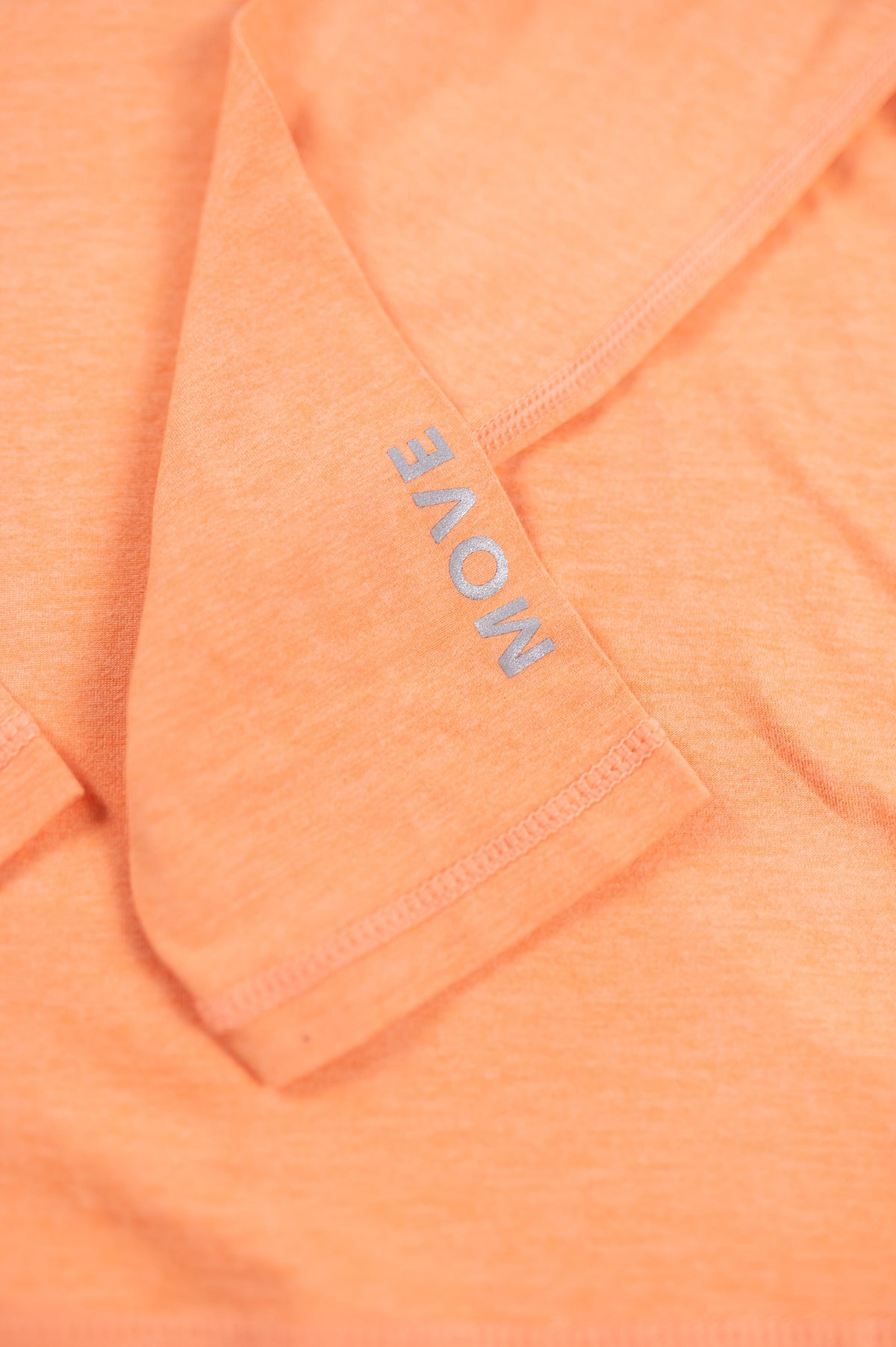 MOVE Sport Apparel women’s Black Label Lightweight Sun Hoodie: Close view of the original MOVE sleeve marking on the Coral Reef sun hoodie.