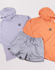 MOVE Sport Apparel women’s Black Label Lightweight Sun Hoodie: Icelandic Blue and Coral Reef sun hoodies arranged with grey shorts.