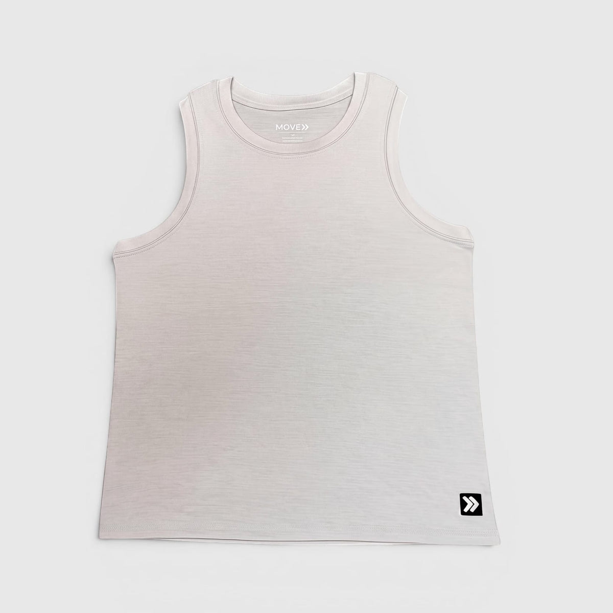 Front view of MOVE Sport Apparel women’s Essential High Neck Tank Top in Silver Cloud, showing the original neckline, cut and lower-hem embellishment.