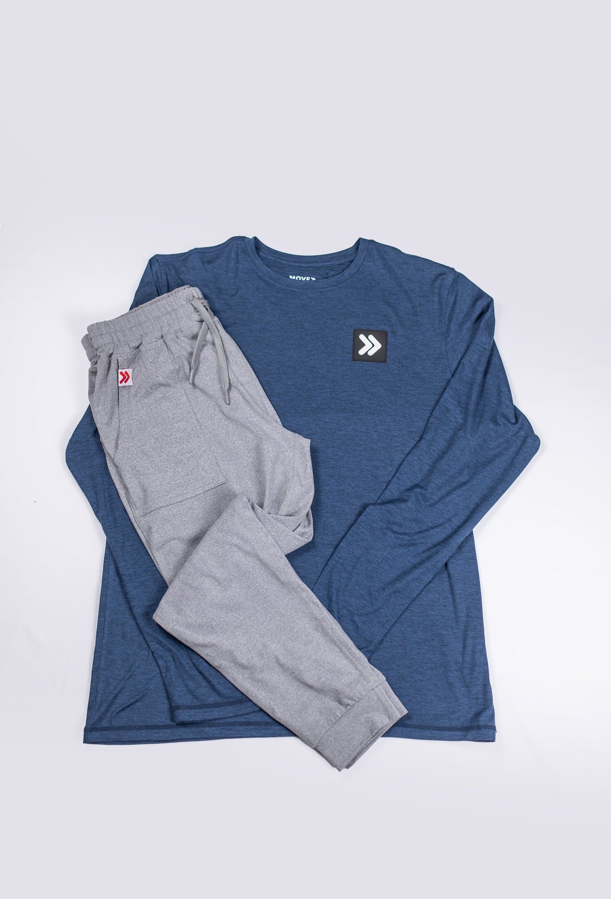 Alternate flat-lay outfit view of grey Essential Joggers and a navy long-sleeve top.