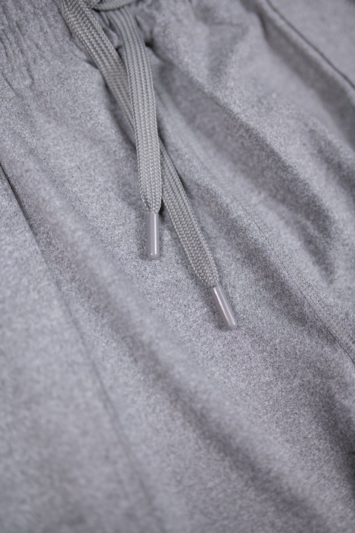 Close-up of the grey Essential Joggers drawstring and fabric.