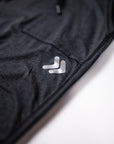 Close-up of the silver 3M reflective double-chevron embellishment on black MOVE Sport Apparel Women’s Essential Joggers.
