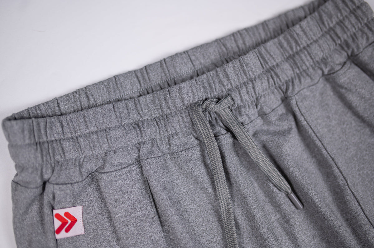 Elastic waistband, stitching and pocket detail on grey Essential Joggers.