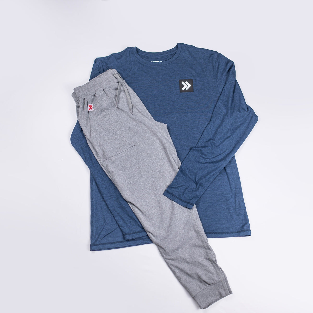 Grey MOVE Sport Apparel women’s Essential Joggers styled with a navy long-sleeve top in a flat-lay outfit.