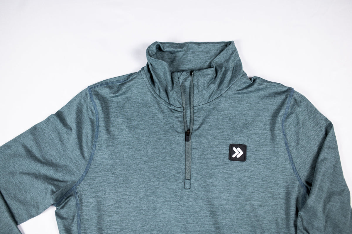MOVE Sport Apparel Women’s Essential Quarter Zip Pro: Balsam Green collar, quarter zipper and original chest patch close-up.