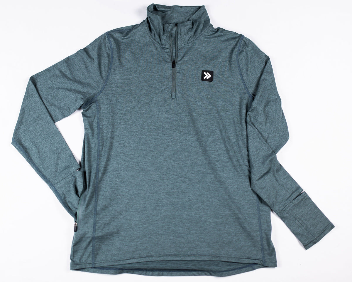 MOVE Sport Apparel Women’s Essential Quarter Zip Pro: Balsam Green laid flat from the front with the original chest patch visible.