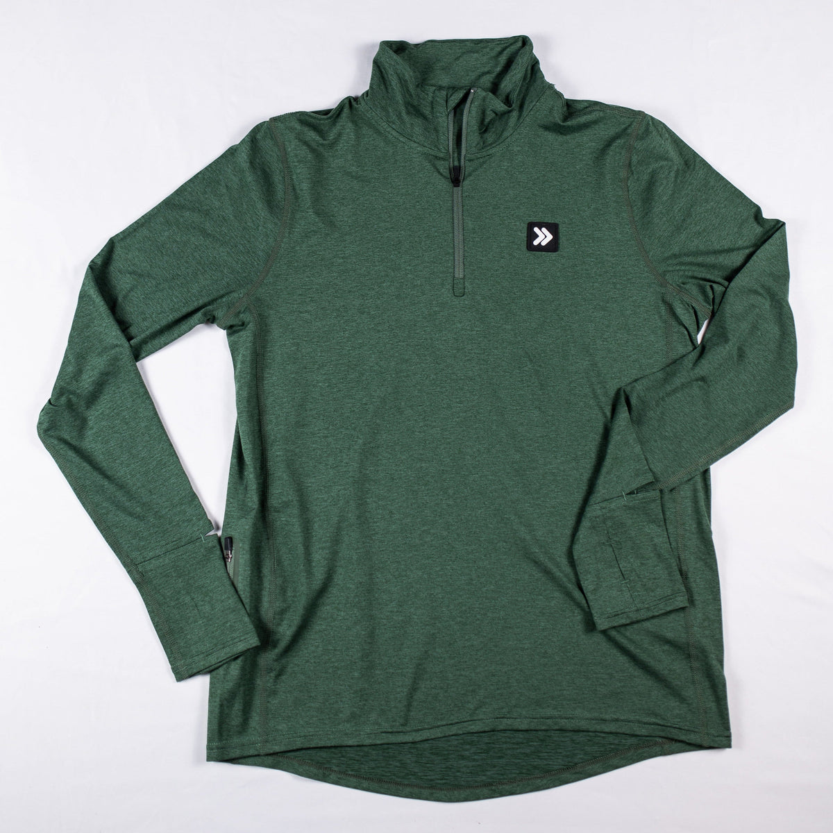 MOVE Sport Apparel Women’s Essential Quarter Zip Pro: Black Forest laid flat from the front with the quarter zipper and original chest patch.