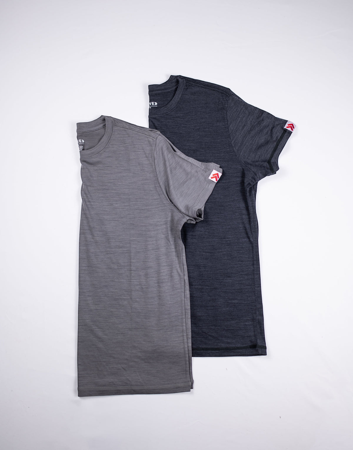 MOVE Sport Apparel women’s Merino Short Sleeve T-Shirt: Black and Granite Gray Merino Short Sleeve T-Shirts arranged together.