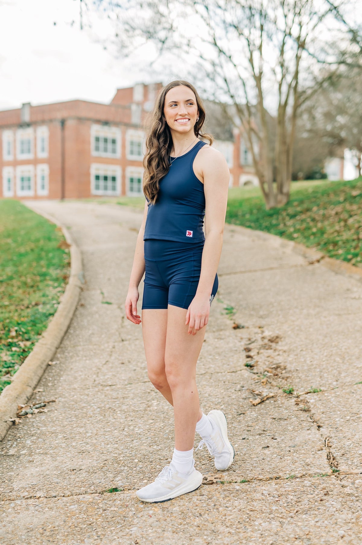 MOVE sport apparel navy blue cropped tank top worn by a woman with matching athletic shorts outdoors