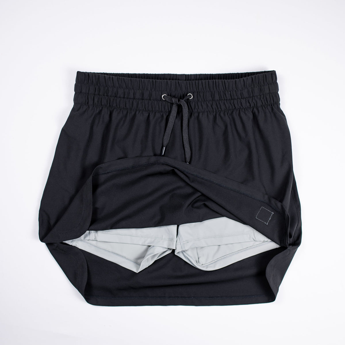 Black MOVE Sport Apparel women’s Skort lifted to show its inner shorts.
