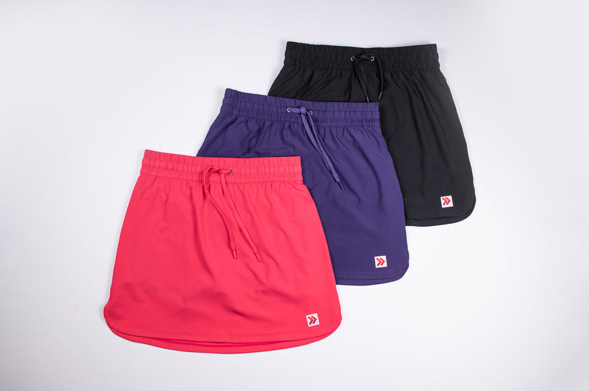 MOVE Sport Apparel women’s Skorts in pink, purple and black arranged together.