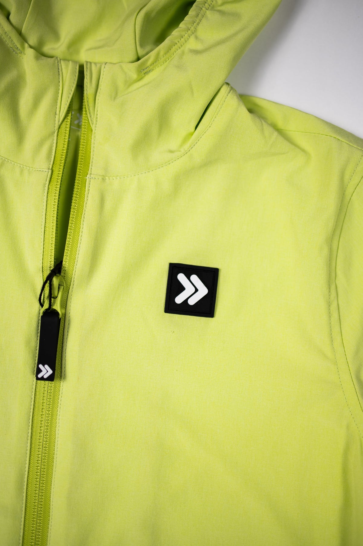Pistachio MOVE Sport Apparel women’s Soft Shell Jacket showing the full-front zipper, raised collar and black chest patch with rounded white MOVE emblem.