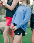 MOVE Sport Apparel women’s Black Label Lightweight Sun Hoodie: Closer view of Deep Periwinkle sun hoodie styled with black athletic shorts at miniature golf.